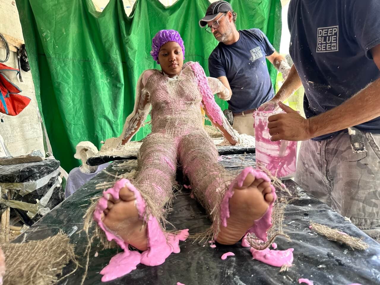 St Maarten team working on a sculpture with a local woman